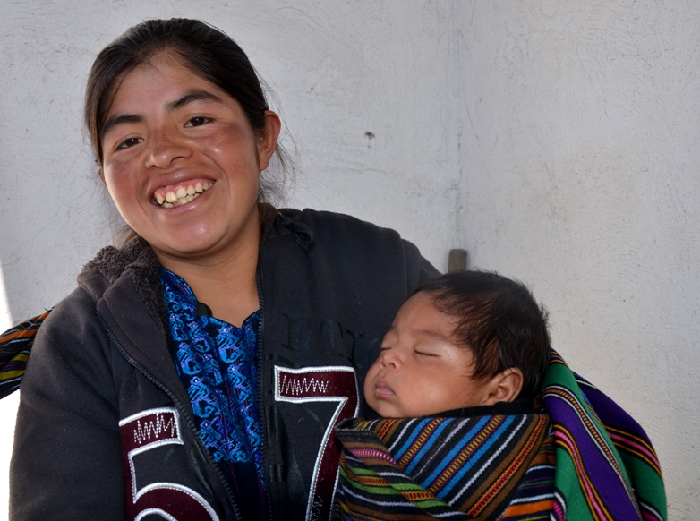 Woman weaver with her baby in Guatemala
